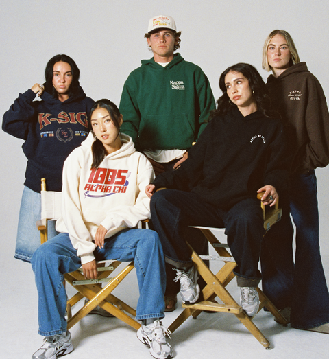 Group of people wearing various sorority and fraternity hoodies and sweatshirts on a plain background