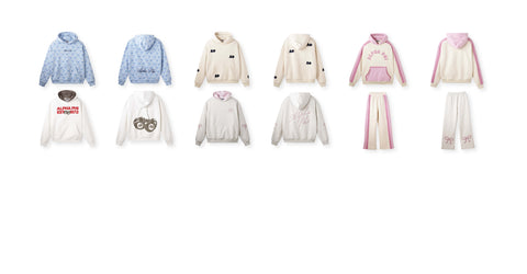 A collection of stylish Alpha Phi hoodies and sweatpants, featuring pastel tones, floral and letter patterns, and playful details like cherries and bows against a white background.