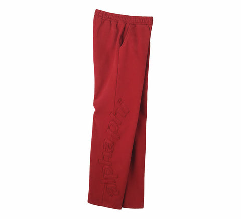 Red sweatpants with patches on a white background
