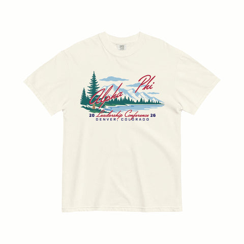 Beige t-shirt with a graphic design of trees, mountains, and text on a white background