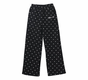 Black pants with white polka dots on a white background