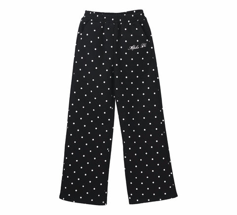 Black pants with white polka dots on a white background