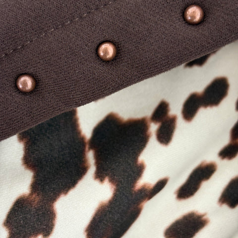 Close-up of hood with studded details and a patterned cow print fabric inner hood